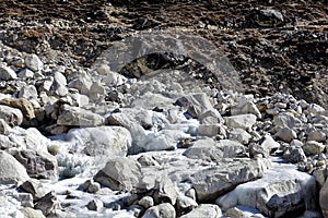 Trekkers walking along a glacial river en route to Everest Base Camp