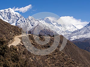 Trekkers Walking on the Trail to Everest Base Camp in Nepal photo