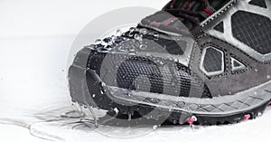 trekking boots in water drops on a white background