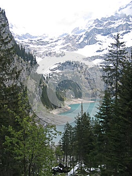 Trekking down to a mountain lake , Alps , Switzerland