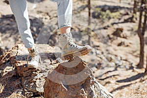 Trekking shoes on a rocky land, close-up