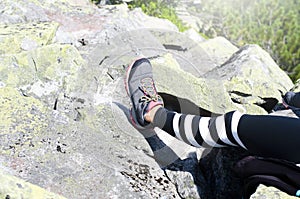 Trekking shoes sneakers. Tourist`s foot. Hiking in the mountains.