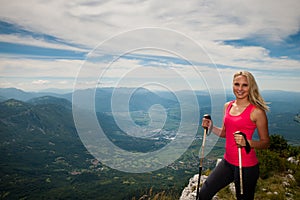 Trekking - woman hiking in mountains on a calm sumer day