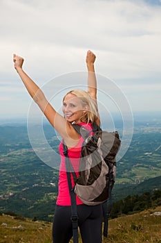 Trekking - woman hiking in mountains on a calm sumer day being