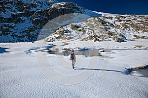 Trekking woman walking in snow