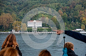 TREMEZZO, ITALY - OCTOBER 02,2023 - Tourists on a boat enjoying the view to iconic villa Carlotta at lake Como