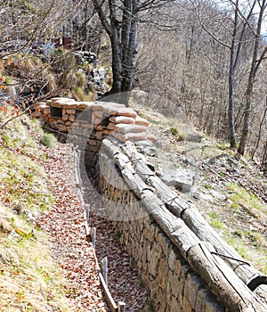 trench dug into the rock by soldiers during the war with sandbags