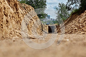 The trench for laying and installation of water pipes.The reinforced concrete well is covered with waterproofing mastic