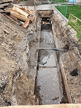 Trench with pipes, repair work on the water supply