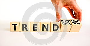 Trend or trendwatching symbol. Concept words Trend and trendwatching on wooden cubes. Businessman hand. Beautiful white table