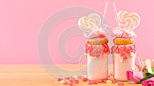 Valentine`s Day freak shakes with heart shaped lollipops and donuts. photo