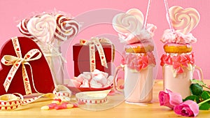 Valentine`s Day freak shakes with heart shaped lollipops and donuts. photo