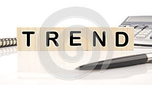 Trend a word written on wooden cubes on a white background. Business, trend or megatrend concept