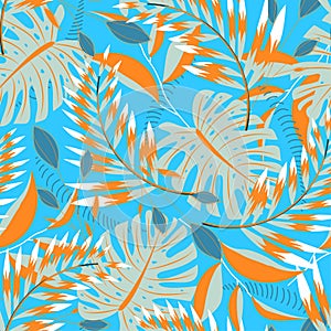 Trending tropical seamless pattern with bright leaves and plants on blue background. Vector design. Jungle print. Floral backgroun