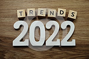 Trends 2022 word alphabet letters on wooden background