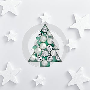 Trendy aqua menthe xmas tree made of white and silver bauble. Square composition, flat lay, view from above. Abstract white star