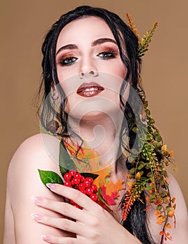 Trendy autumnal makeup . Fashion beauty model girl. Closeup portrait isolated on beige background