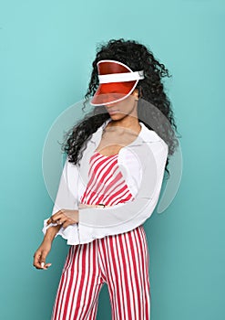 Trendy black women in red and white ensemble with visor
