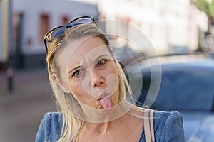 Trendy blond woman pulling a funny face