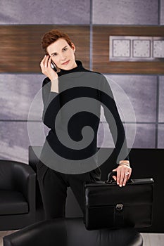 Trendy businesswoman taking mobile call