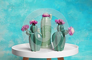 Trendy cactus shaped ceramic vases with flowers