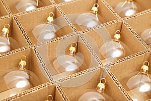 Trendy Christmas background. Transparent glass Christmas balls in box ready for holiday compositions. Christmas market