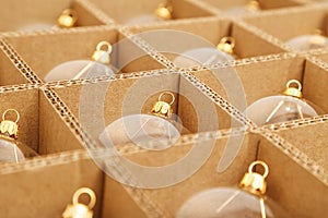 Trendy Christmas background. Transparent glass Christmas balls in box ready for holiday compositions. Christmas market