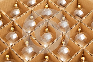 Trendy Christmas background. Transparent glass Christmas balls in box ready for holiday compositions. Christmas market