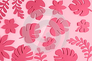 Trendy color of the year 2023. Tropical pattern made with bright paper flowers and leaves toned in viva magenta color, as backdrop