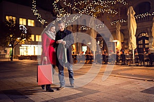 Trendy couple is walking with shopping bag in the city center