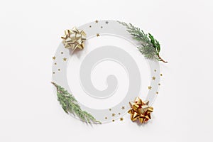 Trendy creatiove Christmas  winter  new year composition. Fir tree branches  golden decorations on beige background.