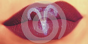 Trendy Creative lip makeup. Closeup Shiny glossy lips with Aries photo