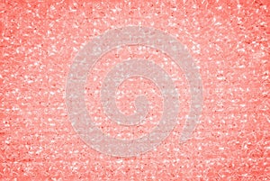 Trendy crystal glitter texture in coral color. Glittery shiny lights background