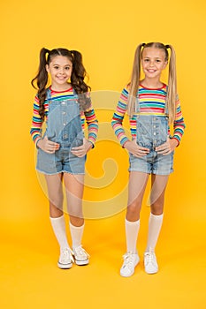 Trendy and fancy. Little girls wearing rainbow clothes. Matching outfits. Fashion shop. Must have accessory. Vibrant