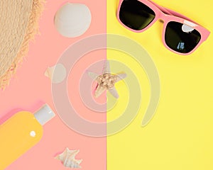 Trendy fashion beach accessories on a bright colorful background. Dried starfish, shells, a bottle of sunscreen lotion, a fragment