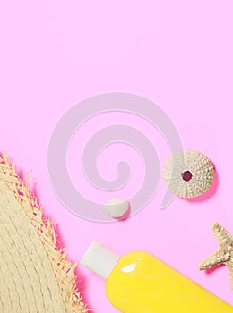 Trendy fashion beach accessories on a bright colorful background. Dried starfish, shells, a bottle of sunscreen lotion, a fragment