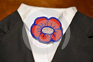 Trendy fashion Brooch on a white shirt with a black jacket - handmade red flower embroided with beads, office style