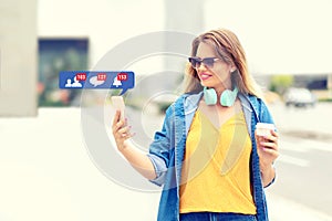 Trendy fashion influencer woman having fun outdoor with new social media mobile app