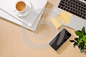 Trendy feminine home office workspace. White office desk. Laptop, coffee cup and phone, notebook, pencil. Flat lay, top view, copy