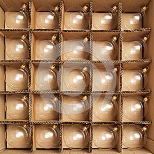 Trendy flat lay Christmas background. Transparent glass Christmas balls in box ready for holiday compositions. Christmas