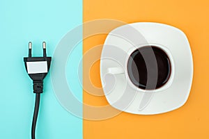 Trendy flat lay minimal concept, unplugged cord and cup of coffee on bright background, concept of a break, rest from modern tech