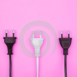 Trendy flat lay minimal concept, unplugged cord on pink background.