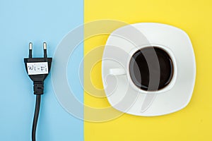 Trendy flat lay minimal concept, unplugged cord with word wi-fi and cup of coffee n bright background, concept of a break, rest fr