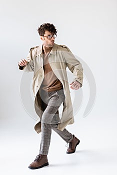 Trendy, frightened man running and looking