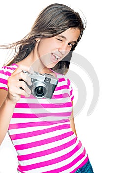 Trendy and funny young girl holding a compact camera