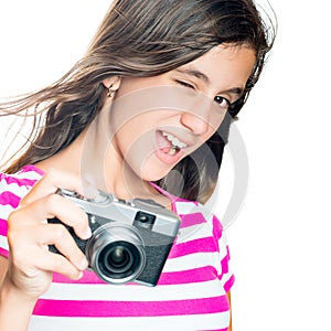 Trendy and funny young girl holding a compact camera