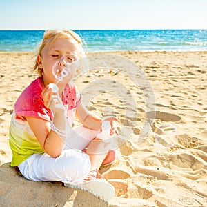 Trendy girl on seacoast blowing bubbles