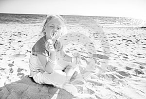 Trendy girl on seacoast blowing bubbles