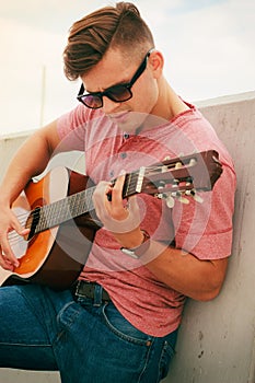 Trendy guy with guitar outdoor