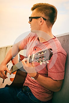 Trendy guy with guitar outdoor